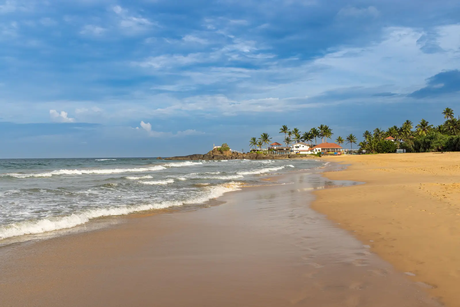 The wide sandy beach and palms at Bentota, Sri Lanka