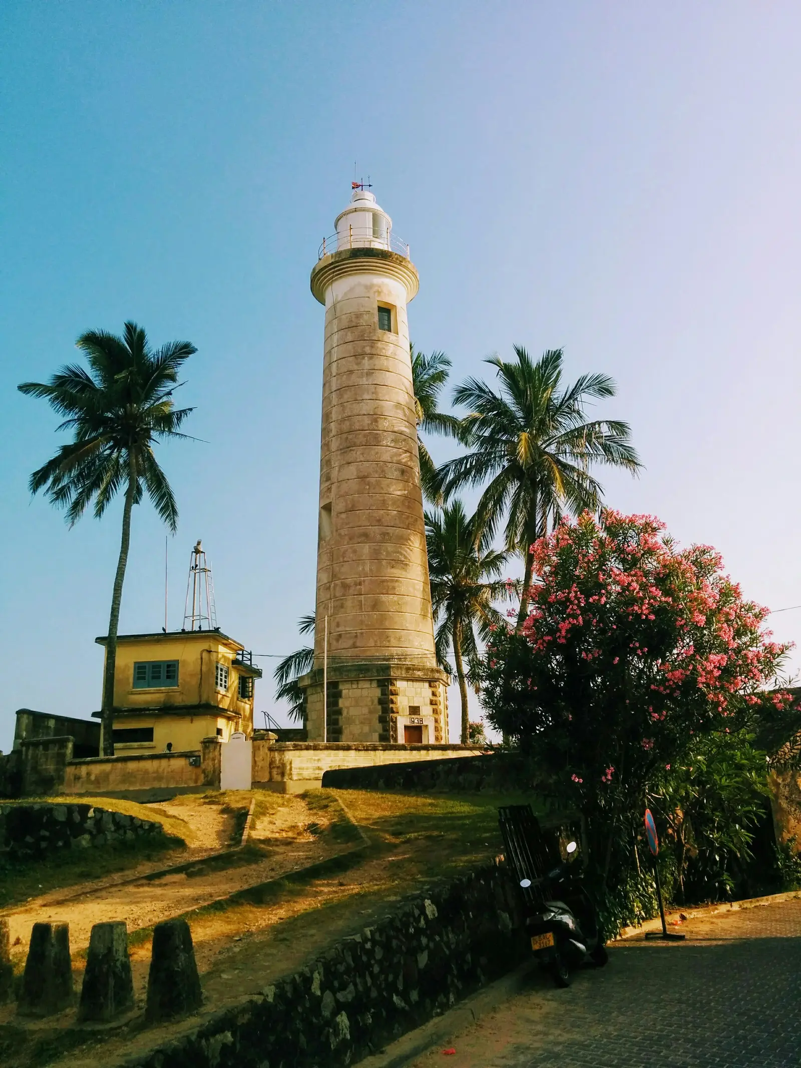 Galle Lighthouse rising above palm trees on Sri Lanka's south coast