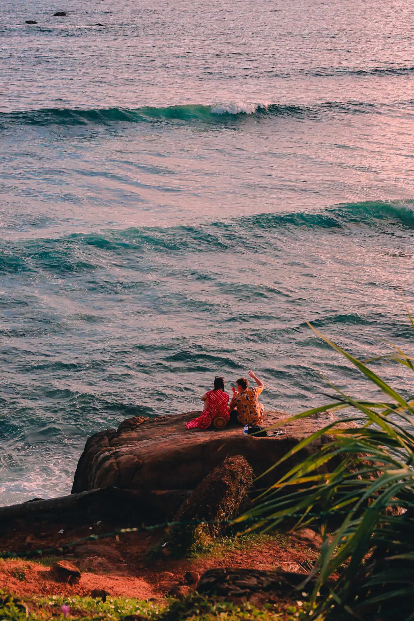 Travellers watching the Indian Ocean at sunset