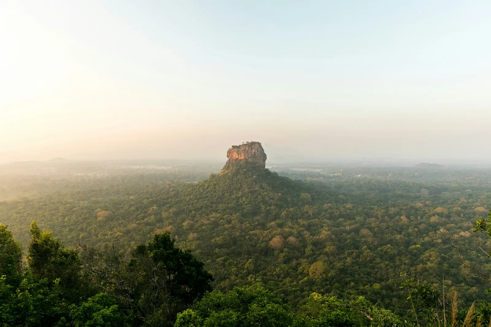 Sigiriya Rock Fortress surrounded by mist and jungle