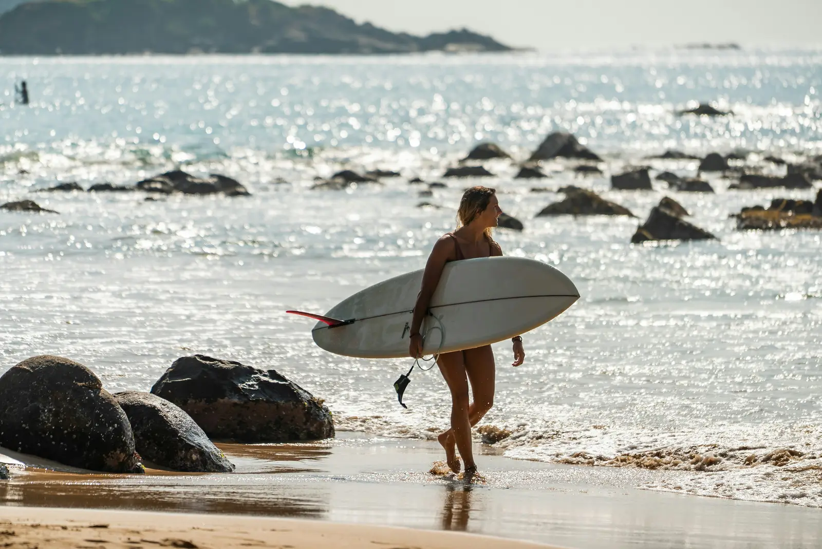 Surfer on golden sand